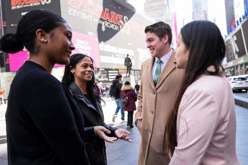 Students talk and smile in Times Square.